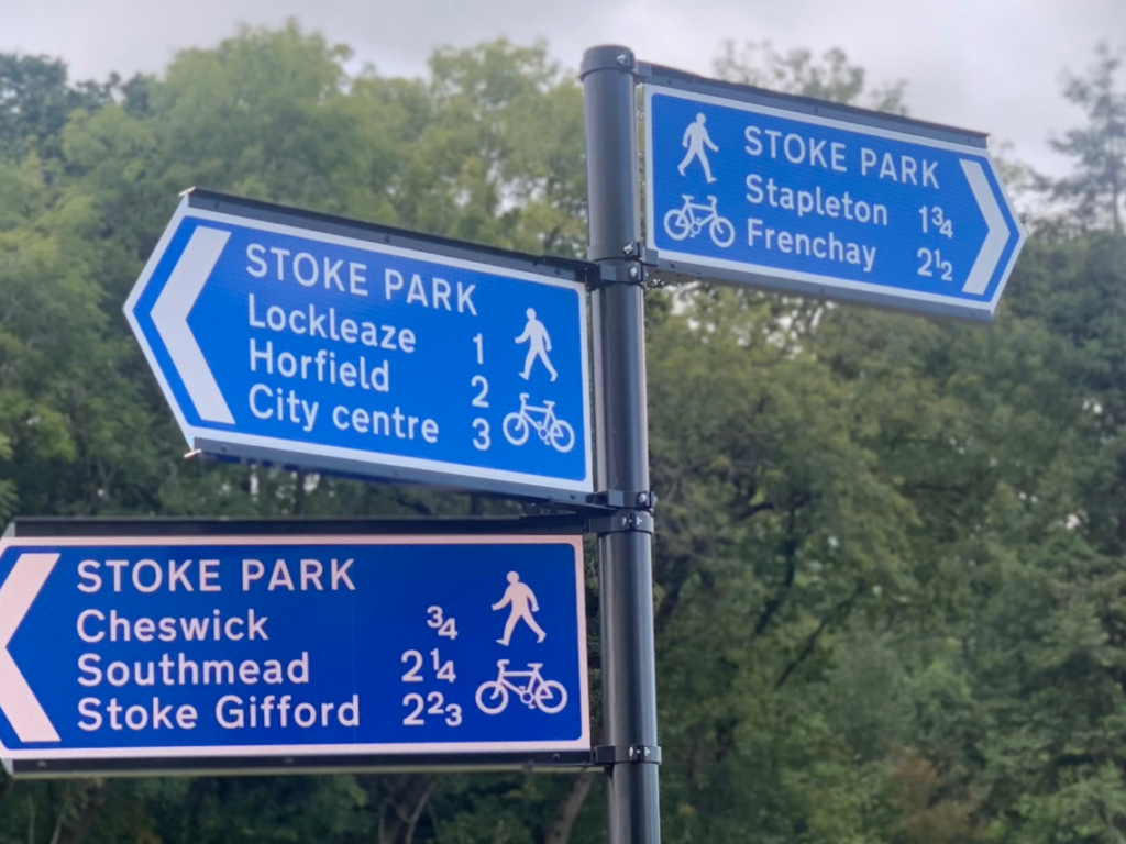 Walking distance signs in a park